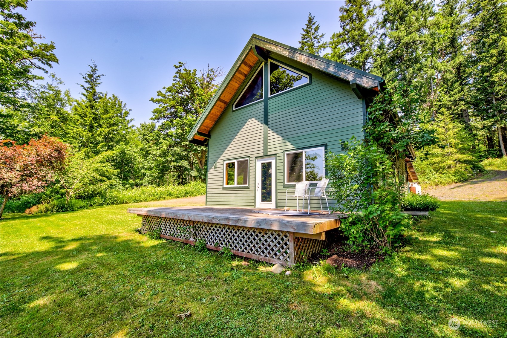 832 Lakenes Road Quilcene, WA 98376 - Photo 3 of 38 a view of a house with a yard and sitting area