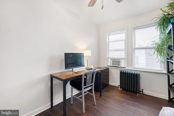 a view of a workspace with furniture and a window