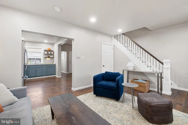 a living room with furniture and a stairs