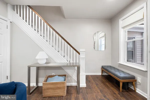a living room with furniture and a stairs