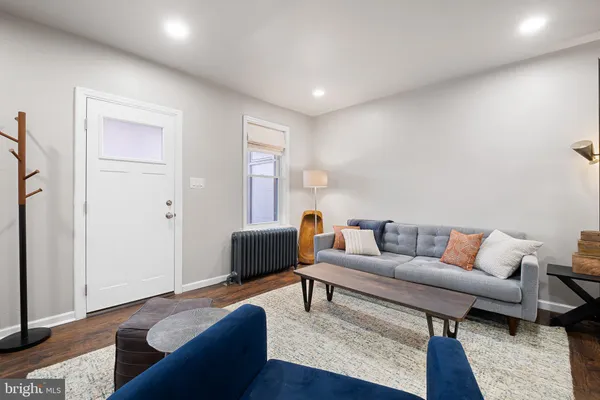 a living room with furniture and a rug