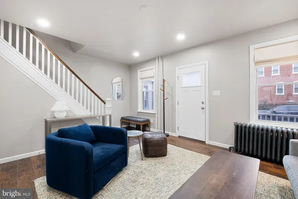 a living room with furniture ceiling fan and a rug