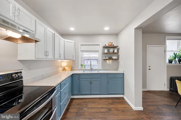 a kitchen with stainless steel appliances granite countertop a stove and a sink