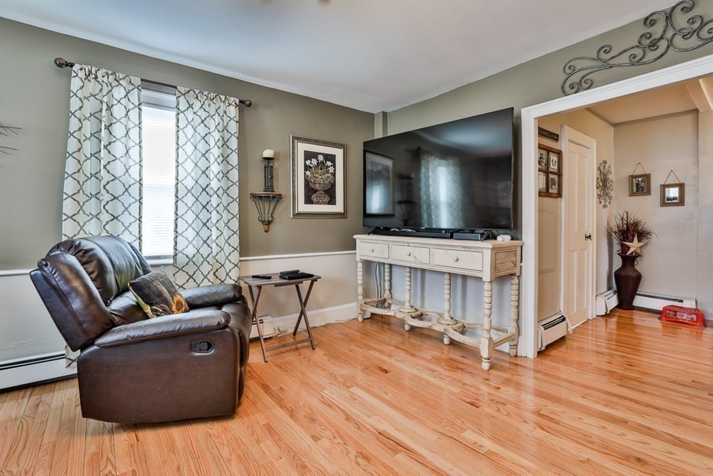50 Mission Road Tyngsborough, MA 01879 - Photo 13 of 41 a living room with furniture and a flat screen tv