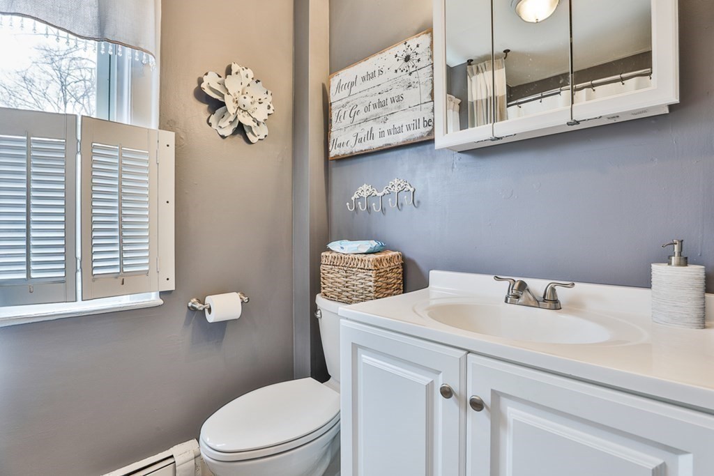 50 Mission Road Tyngsborough, MA 01879 - Photo 14 of 41 a bathroom with a toilet sink and mirror