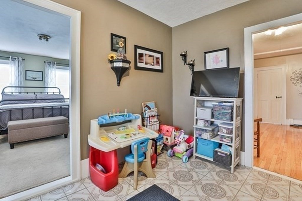 50 Mission Road Tyngsborough, MA 01879 - Photo 18 of 41 a living room with furniture and a flat screen tv