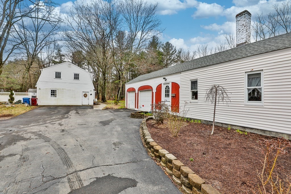 50 Mission Road Tyngsborough, MA 01879 - Photo 2 of 41 a view of a white house with a large tree