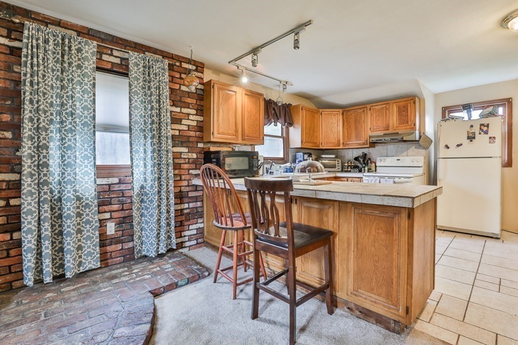 50 Mission Road Tyngsborough, MA 01879 - Photo 32 of 41 a kitchen with stainless steel appliances a sink stove and cabinets