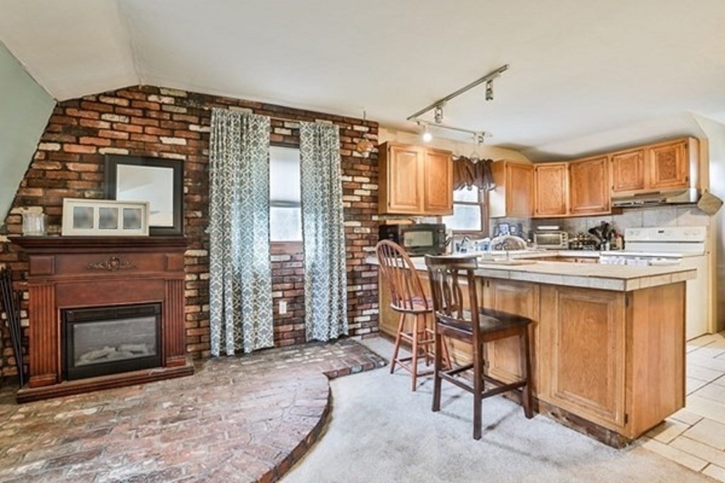 50 Mission Road Tyngsborough, MA 01879 - Photo 33 of 41 a kitchen with stainless steel appliances granite countertop a stove a sink and a refrigerator