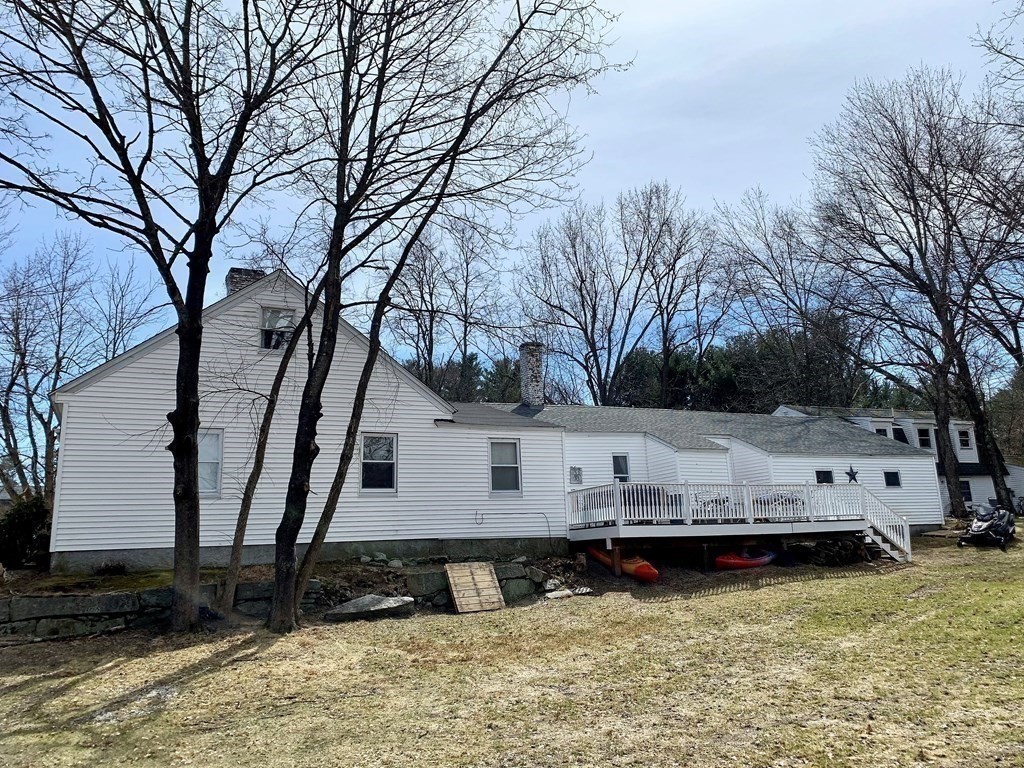 50 Mission Road Tyngsborough, MA 01879 - Photo 38 of 41 a view of backyard with large trees and wooden fence