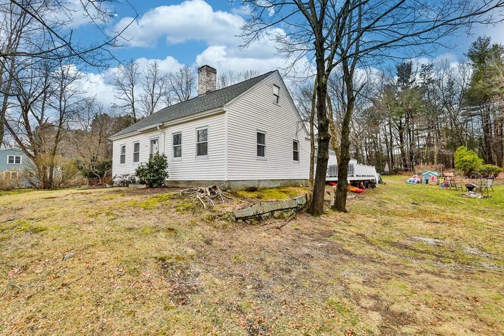50 Mission Road Tyngsborough, MA 01879 - Photo 5 of 41 a view of a yard with a house and a tree