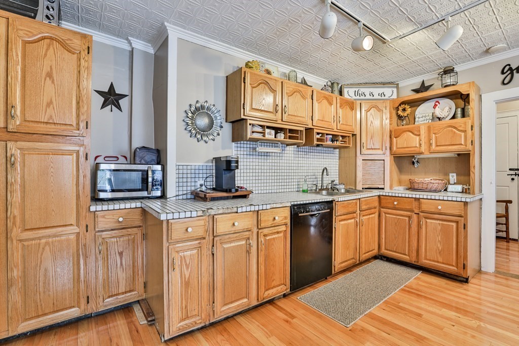 50 Mission Road Tyngsborough, MA 01879 - Photo 8 of 41 a kitchen with stainless steel appliances granite countertop a sink and cabinets