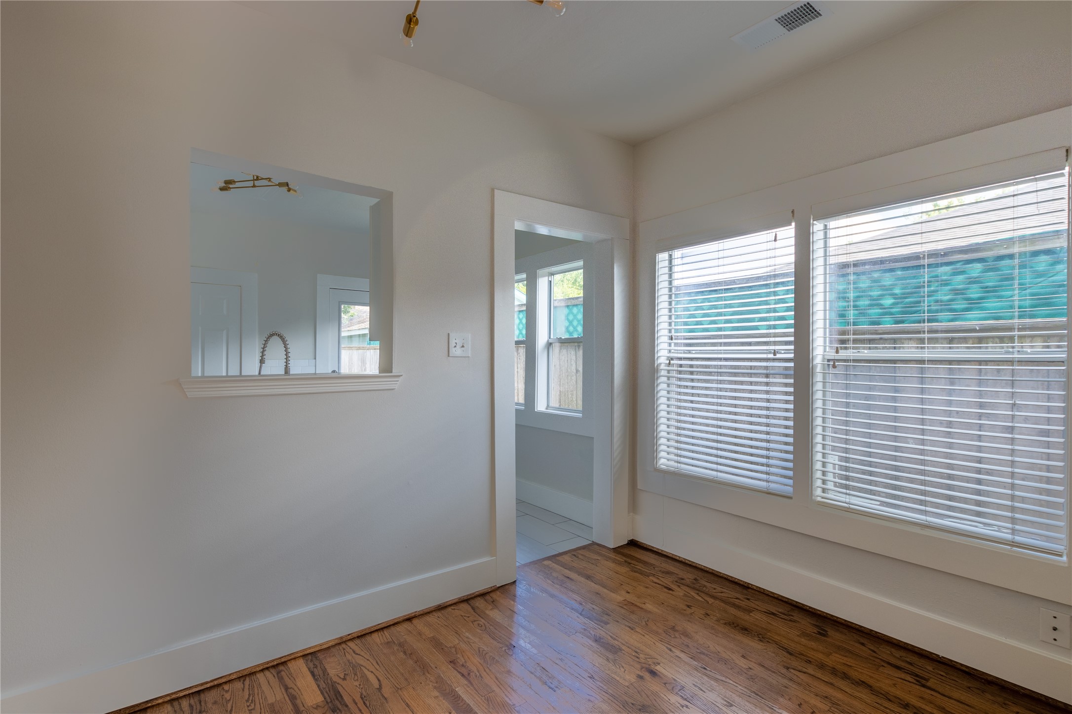 2009 Singleton Street Houston, TX 77008 - Photo 11 of 24 a view of an empty room with wooden floor and a window