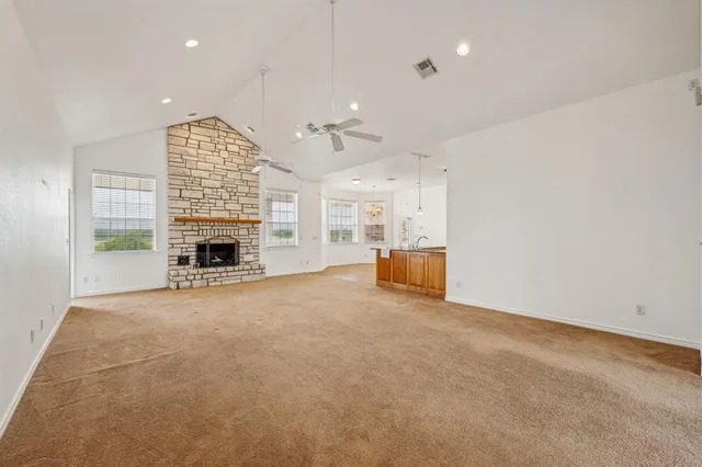 an empty room with furniture and a fireplace