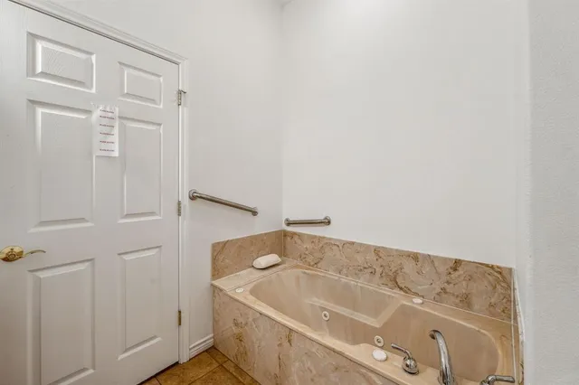 a bathroom with a tub and shower