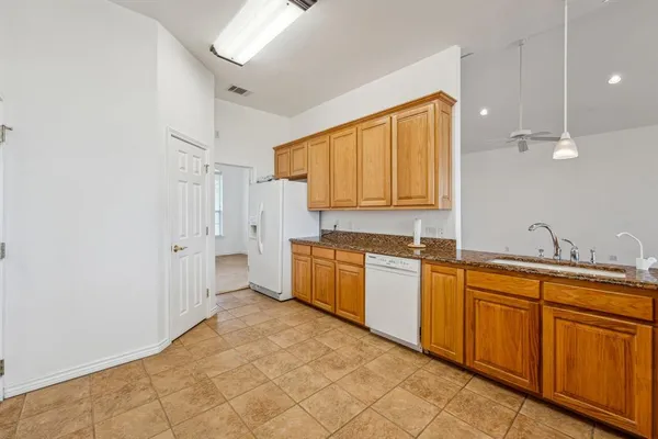 a large kitchen with cabinets and stainless steel appliances