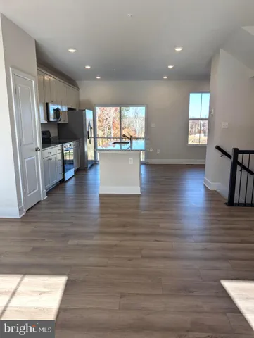 a view of kitchen with cabinets and wooden floor