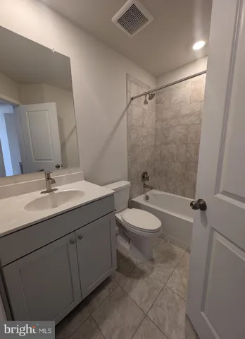 a bathroom with a double vanity sink toilet mirror and shower