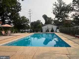 11064 Demarr Road White Plains, MD 20695 - Photo 21 of 98 a view of a swimming pool with a patio
