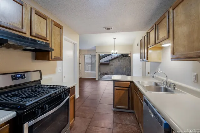 a kitchen with a sink stove and cabinets