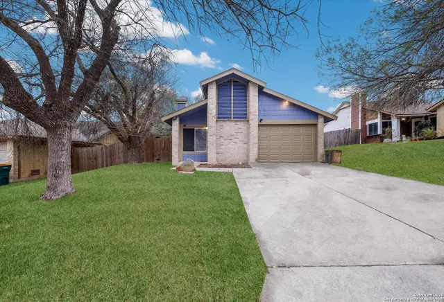 a front view of house with yard and green space