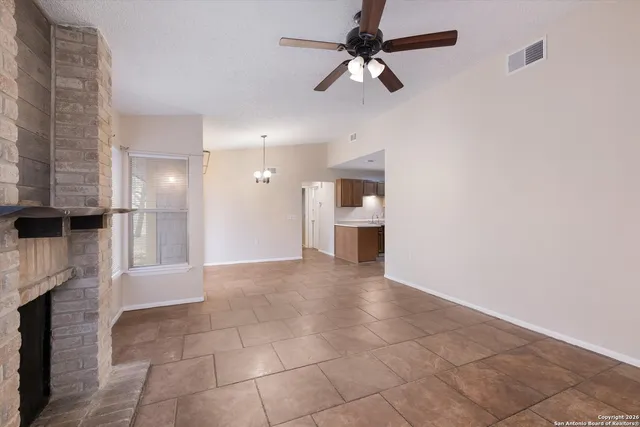 a view of a kitchen with a sink and a fireplace