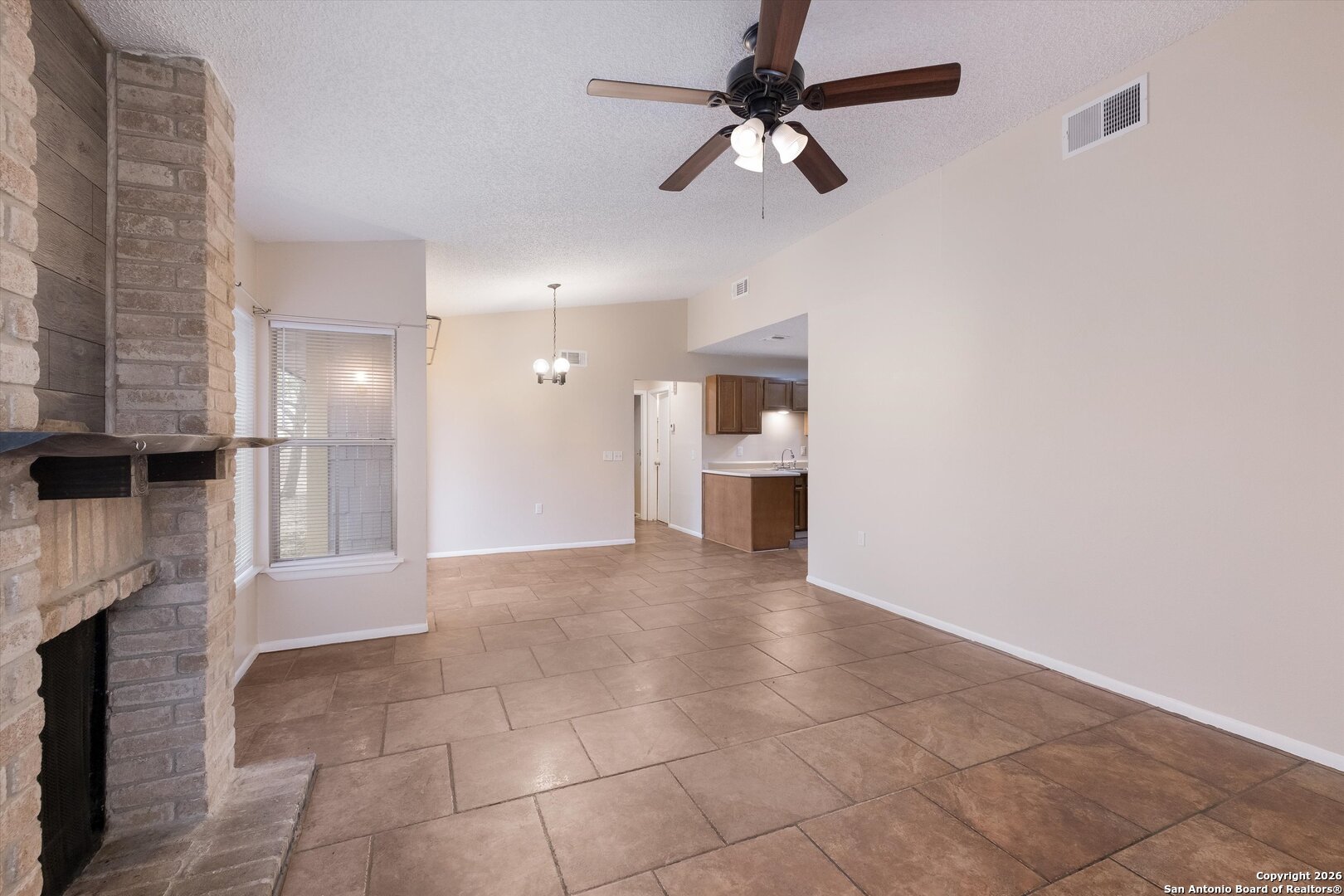 8424 8th Street Converse, TX 78109 - Photo 4 of 22 a view of a kitchen with a sink and a fireplace