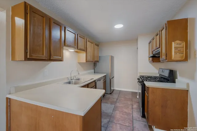 a kitchen that has a sink and a stove