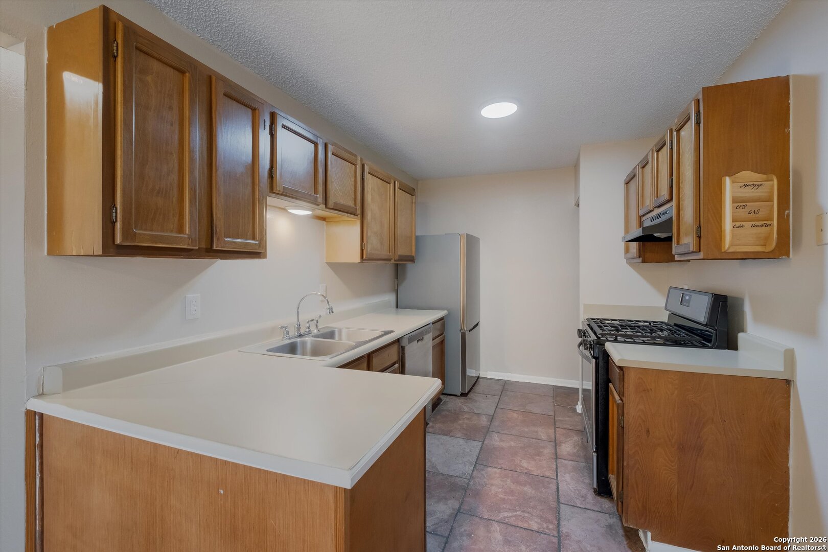 8424 8th Street Converse, TX 78109 - Photo 9 of 22 a kitchen that has a sink and a stove