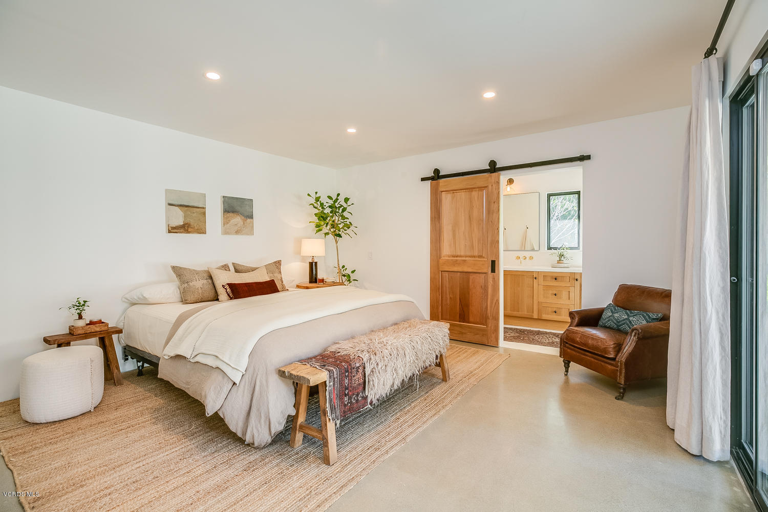 1203 Daly Road Ojai, CA 93023 - Photo 12 of 18 a spacious bedroom with a bed and a couch