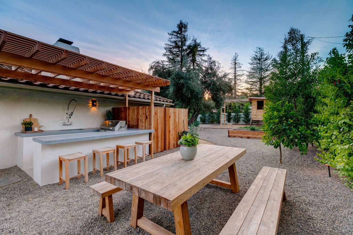 1203 Daly Road Ojai, CA 93023 - Photo 15 of 18 a roof deck with a table and chairs and potted plants