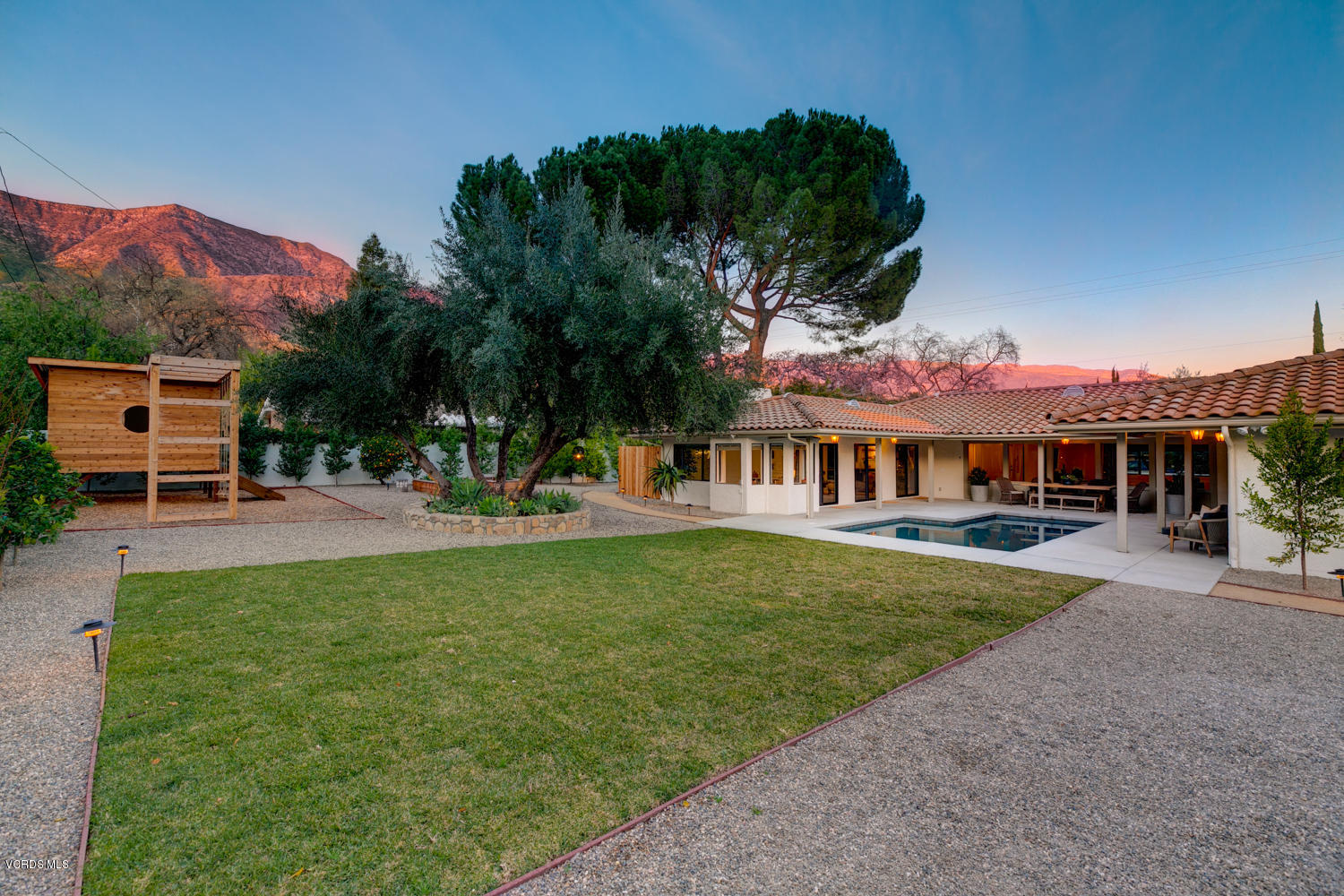 1203 Daly Road Ojai, CA 93023 - Photo 18 of 18 a view of a big house with a big yard and potted plants