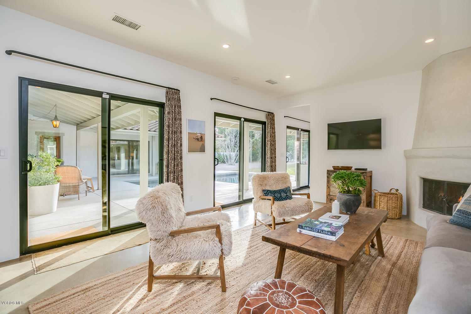 1203 Daly Road Ojai, CA 93023 - Photo 8 of 18 a living room with furniture a fireplace and a floor to ceiling window