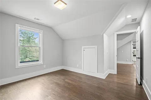 a living room with furniture and wall paintings