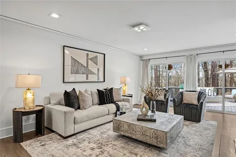 a kitchen with stainless steel appliances kitchen island granite countertop a table chairs sink and cabinets
