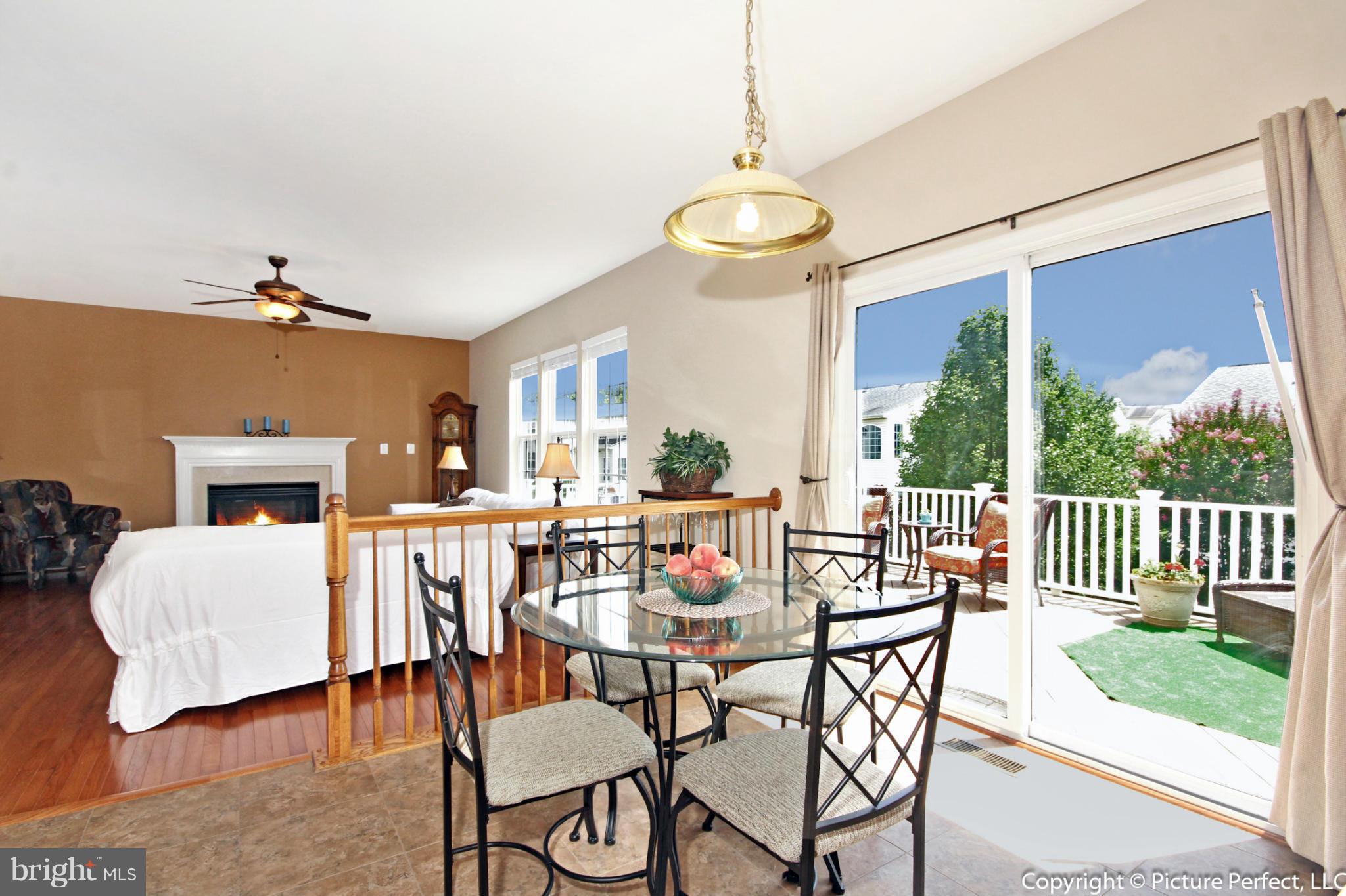 14308 Autumn Crest Road Boyds, MD 20841 - Photo 3 of 21 a view of a dining room with furniture window and wooden floor