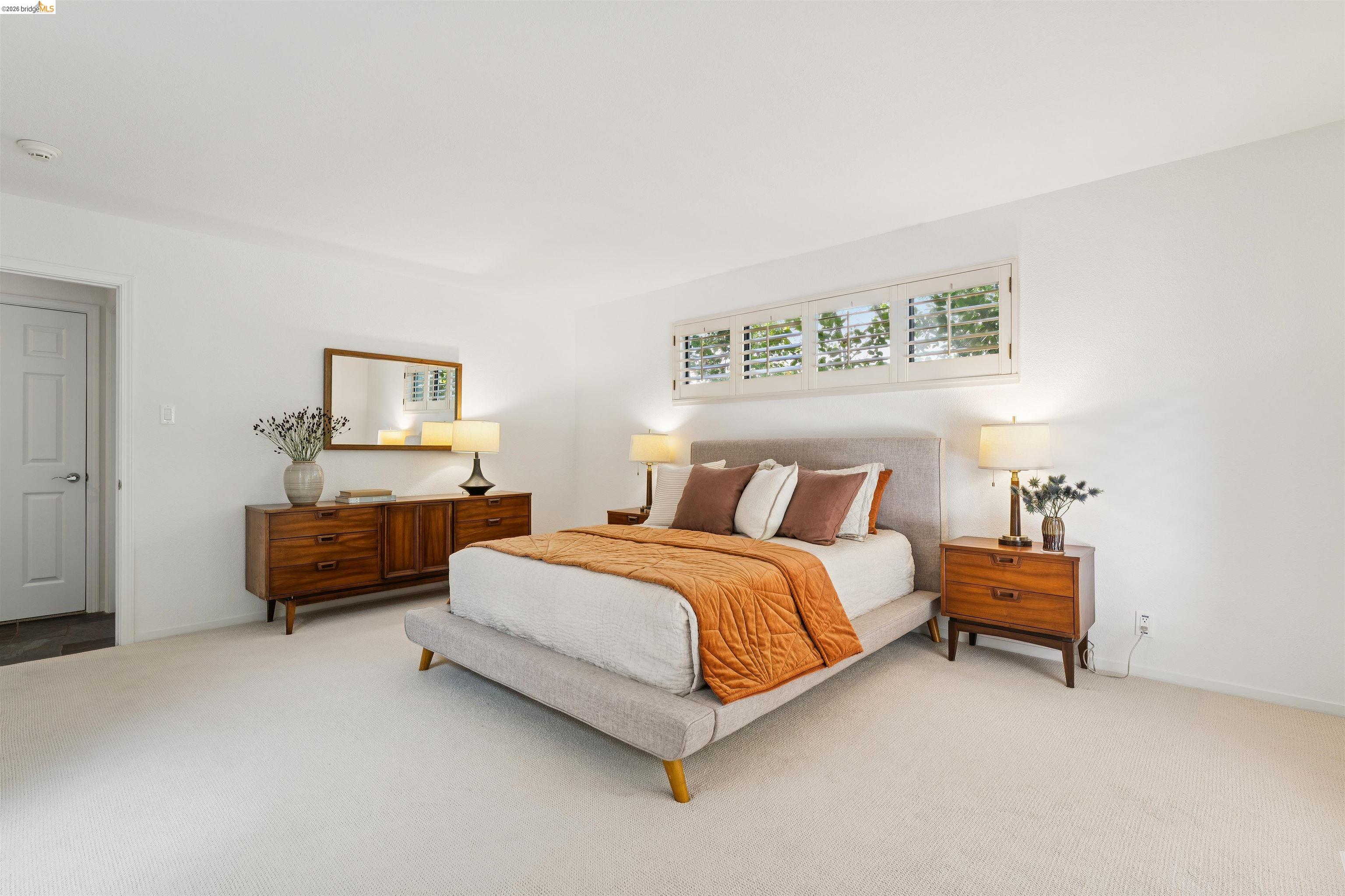 7 Jo Lin Court El Sobrante, CA 94803 - Photo 70 of 99 Light-filled room featuring white walls, plush carpeting, and plantation shutter windows