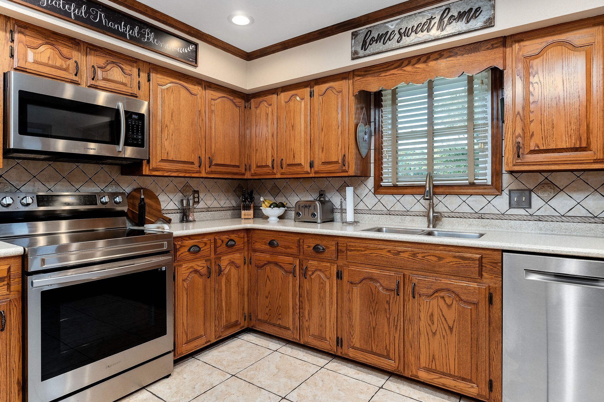 3579 Hilham Road Cookeville, TN 38506 - Photo 12 of 43 a kitchen with stainless steel appliances granite countertop a sink a stove and a microwave