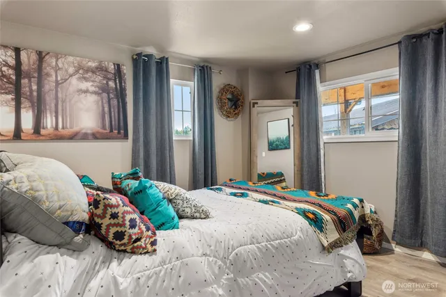 a bedroom with a bed and a window