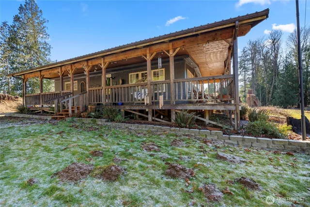 a balcony with chairs and wooden floor