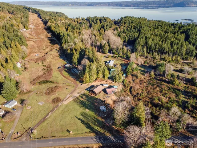 an aerial view of residential house with outdoor space and parking