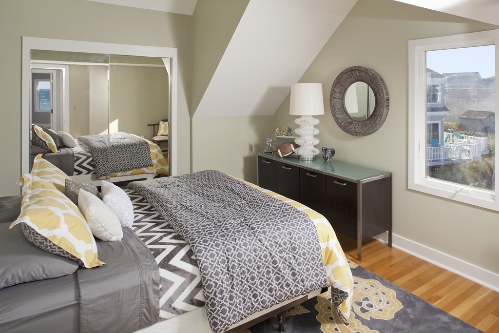 73 Seaside Road Scituate, MA 02066 - Photo 16 of 27 a bedroom with a bed and wooden floor