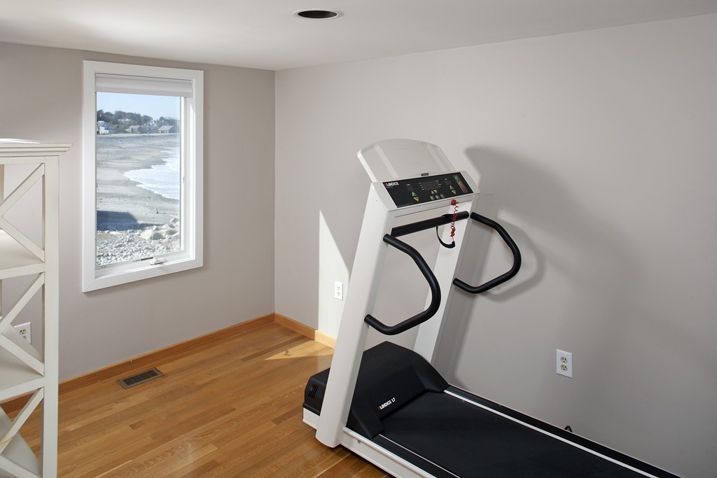 73 Seaside Road Scituate, MA 02066 - Photo 18 of 27 a room with gym equipment on wooden floor
