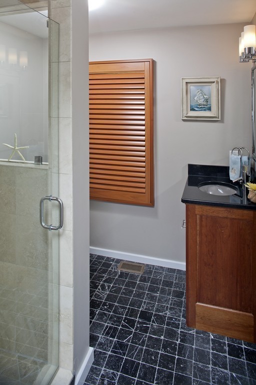 73 Seaside Road Scituate, MA 02066 - Photo 19 of 27 a bathroom with a granite countertop sink a toilet and a mirror
