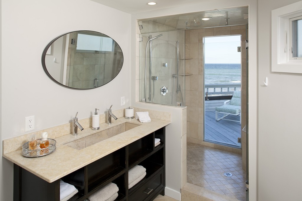 73 Seaside Road Scituate, MA 02066 - Photo 10 of 27 a bathroom with a sink and a mirror