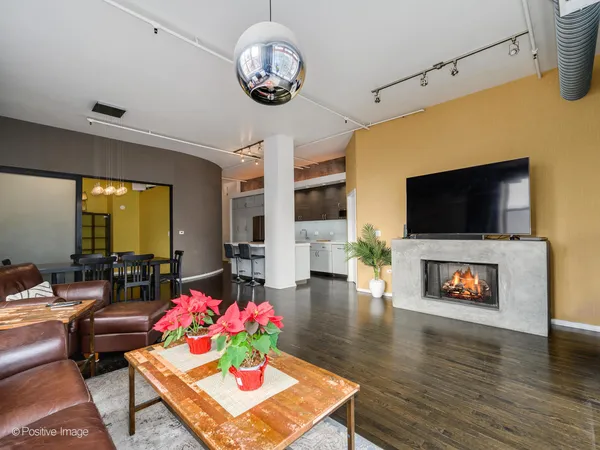 a living room with fireplace furniture and a flat screen tv