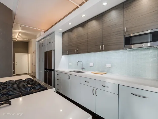 a kitchen with a sink stainless steel appliances and cabinets