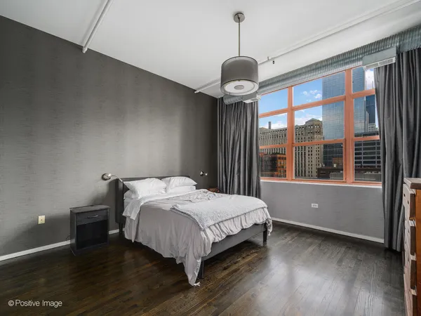 a bedroom with a large bed and a large window