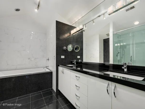 a bathroom with a double vanity sink and mirror