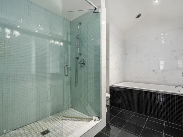 a bathroom with a bathtub and shower
